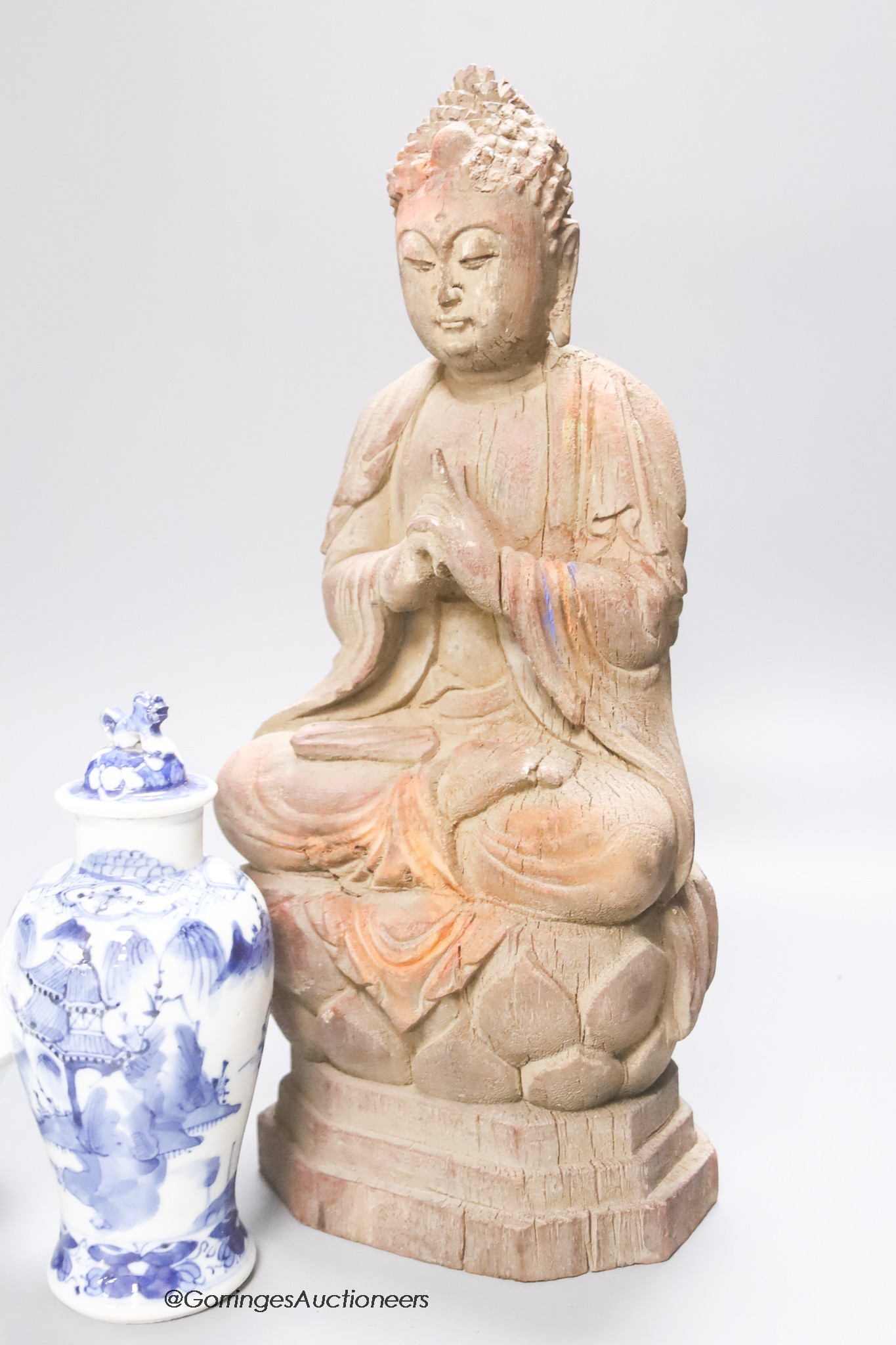 A 20th century carved wooden Buddha, height 34cm, a 19th century Chinese blue and white lidded vase, and a famille rose bowl and cover